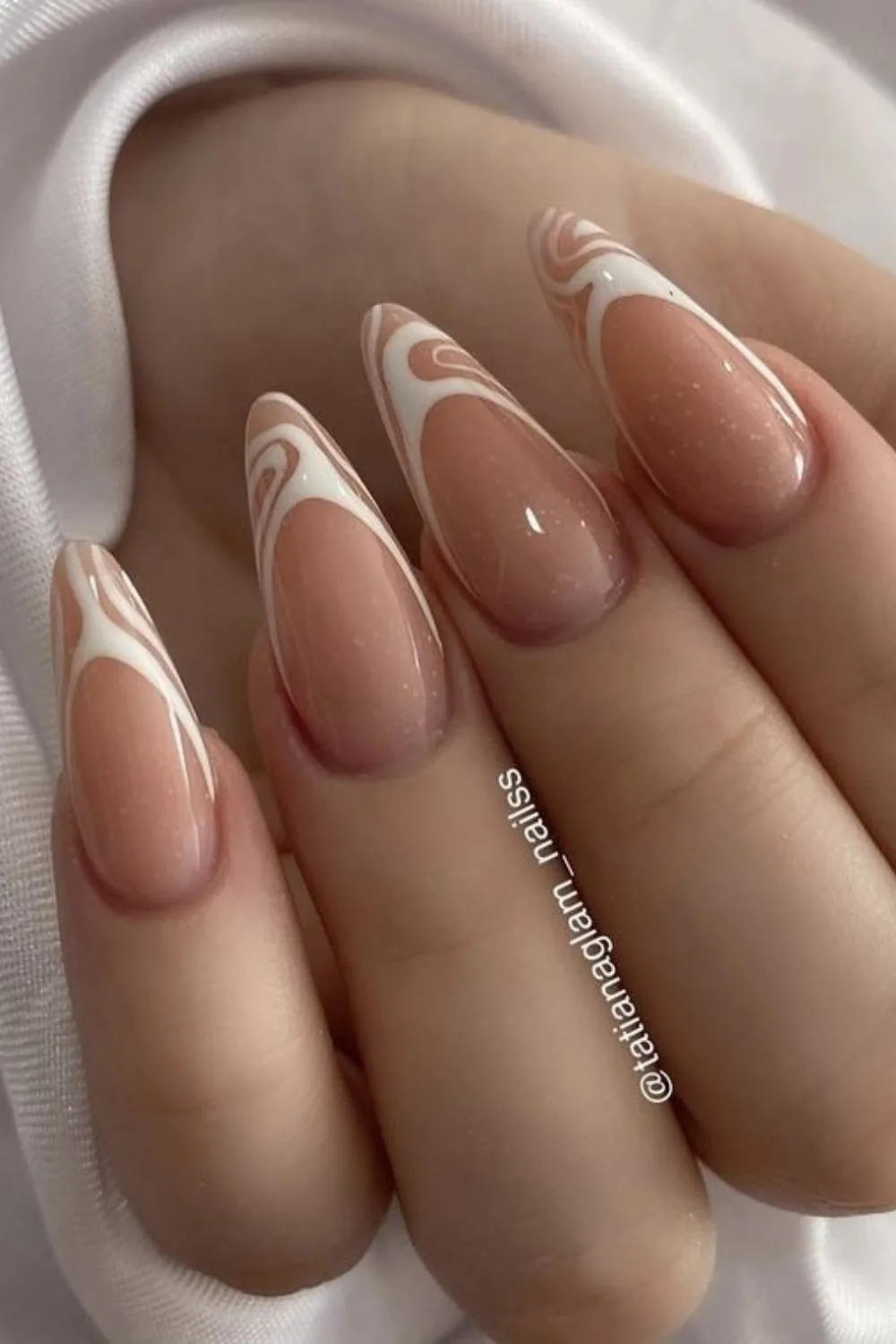 Nude nails with white French tip swirls