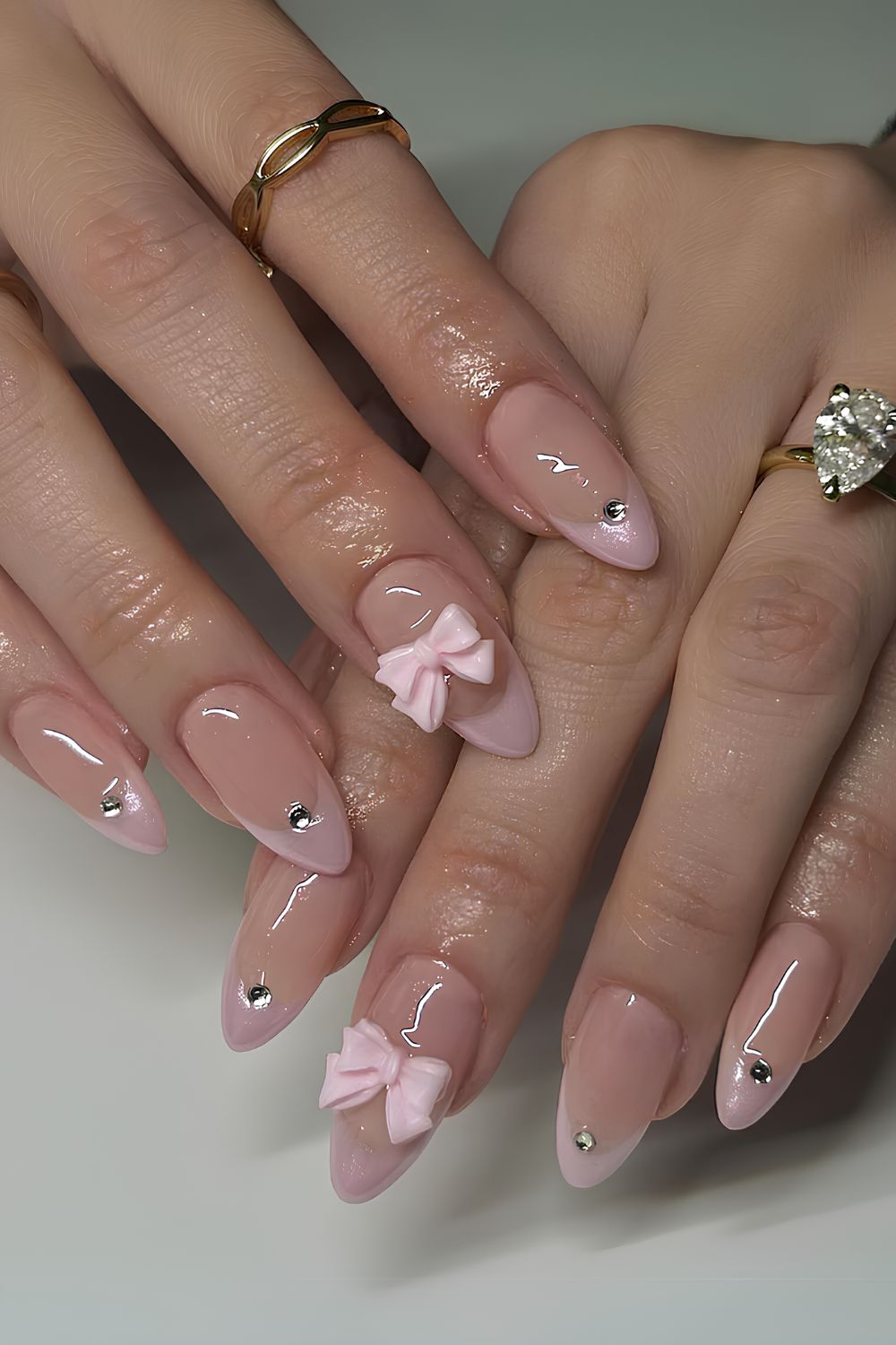 Pink French nails with bows and studs