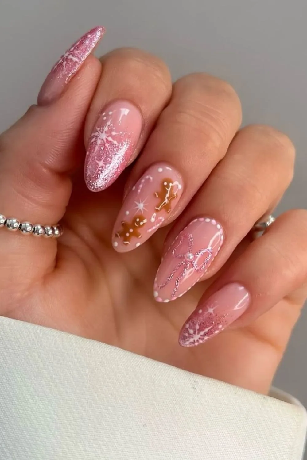 Pink glitter nails with gingerbread and snowflakes