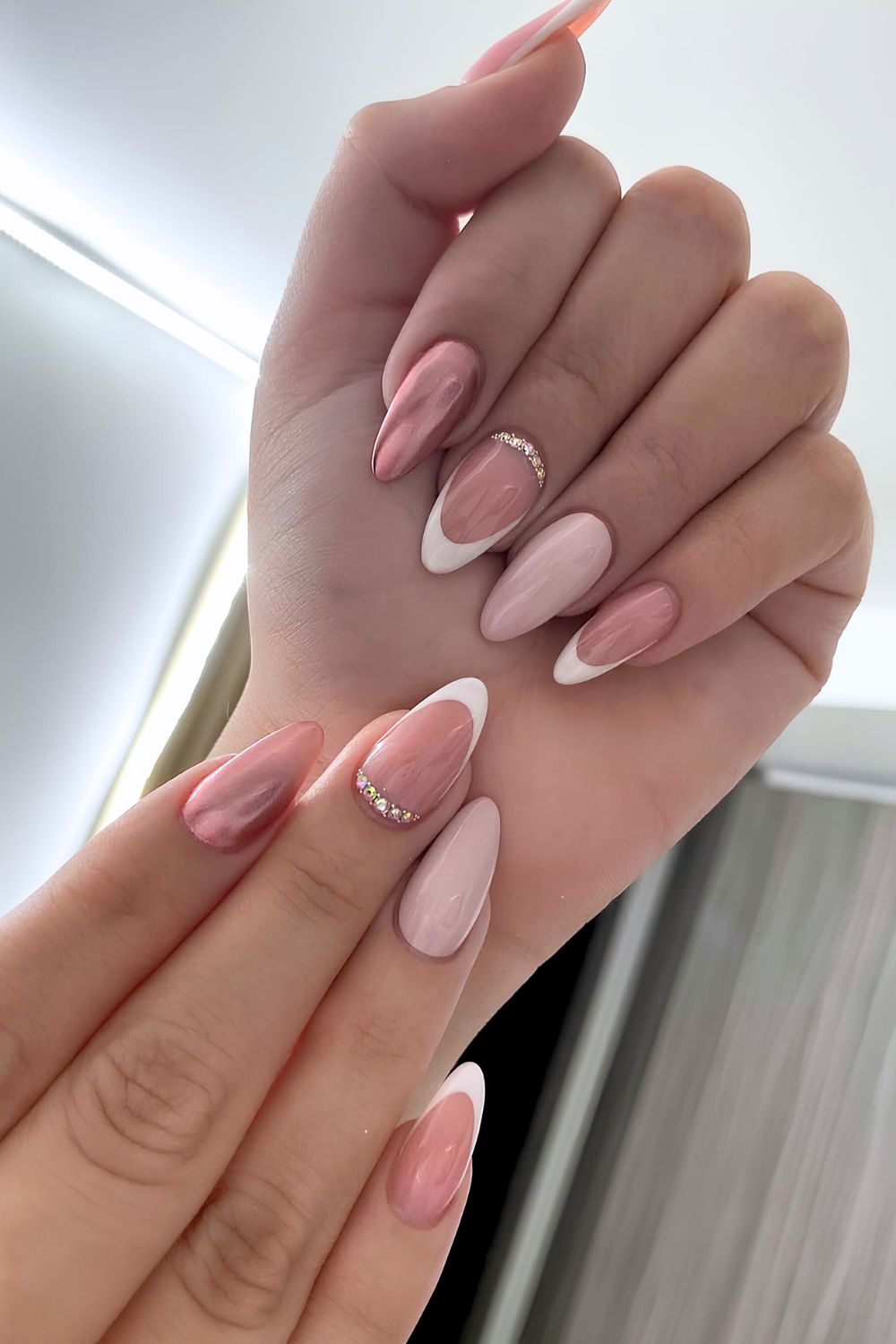 Pink nails with chrome and gem accents