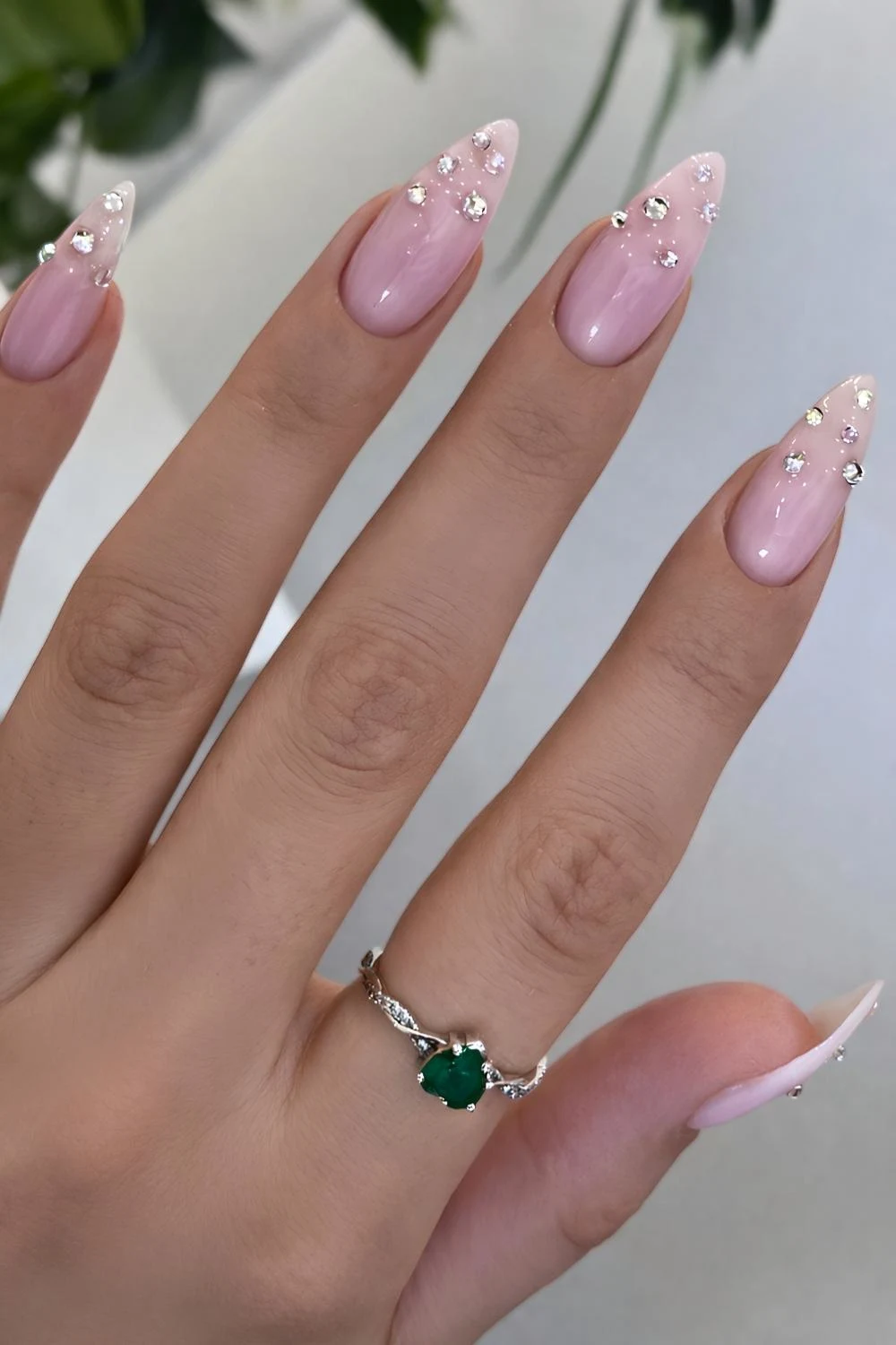 Pink nails with rhinestones at the tips