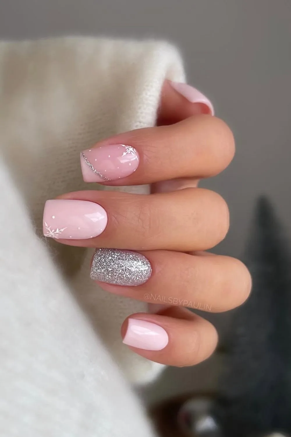 Pink nails with sparkly silver accent nail and snow design