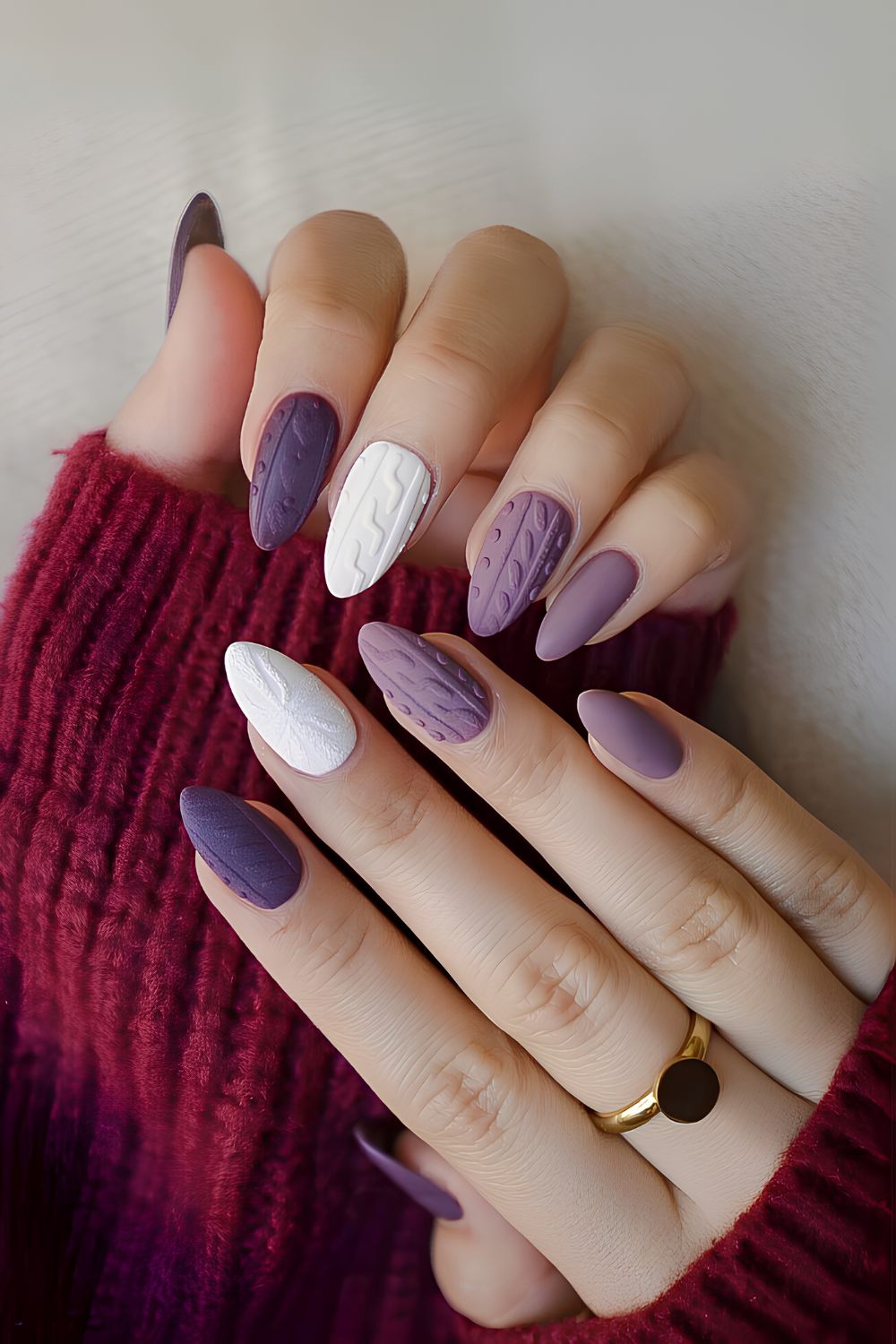 Purple and white nails with sweater pattern art