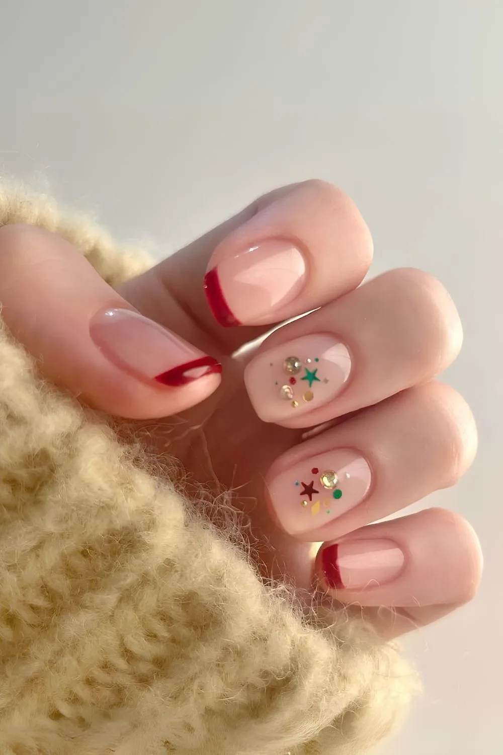 Red Christmas French nails with green glitter accents