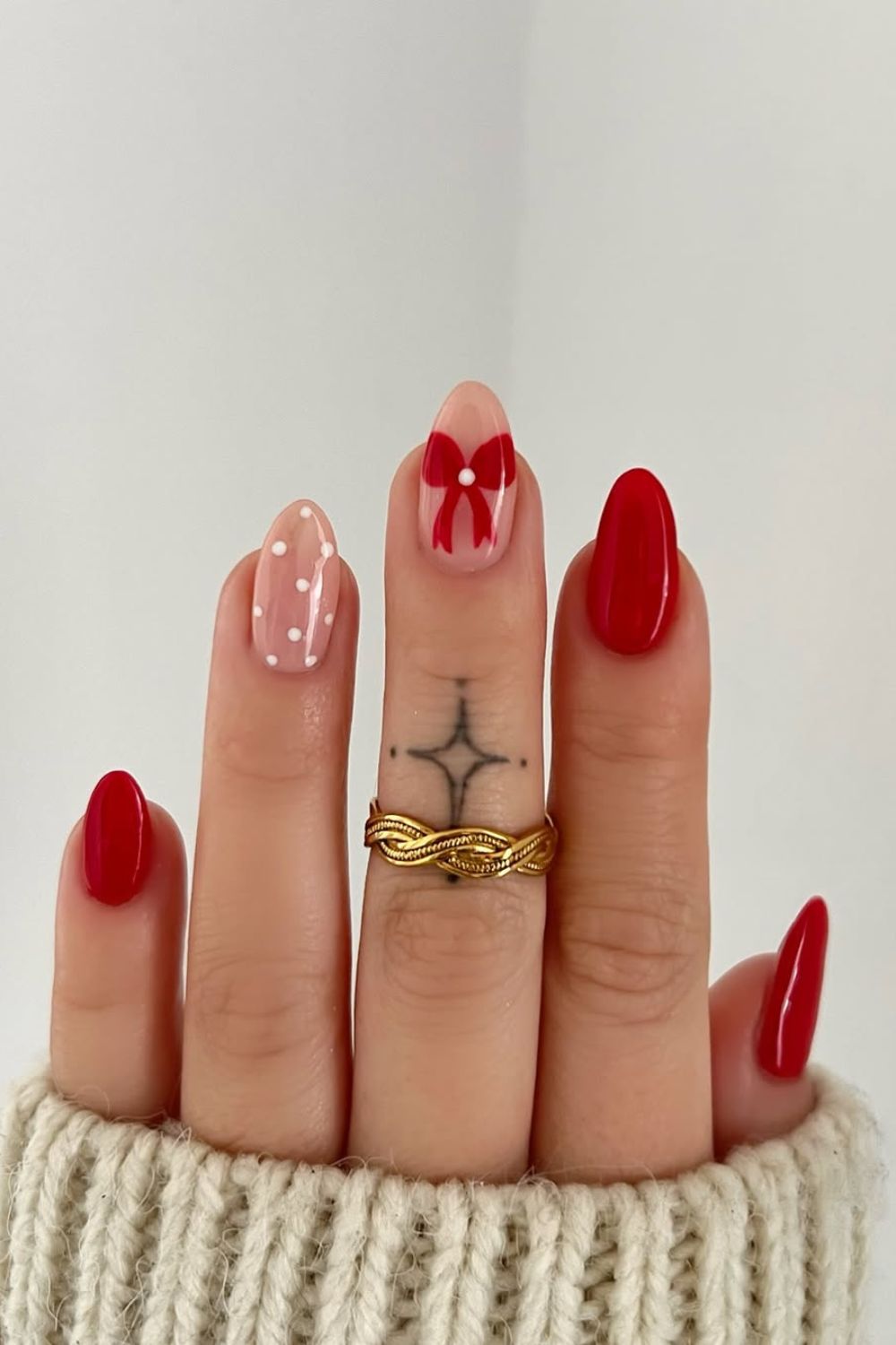 Red Christmas nails with bow and white dots