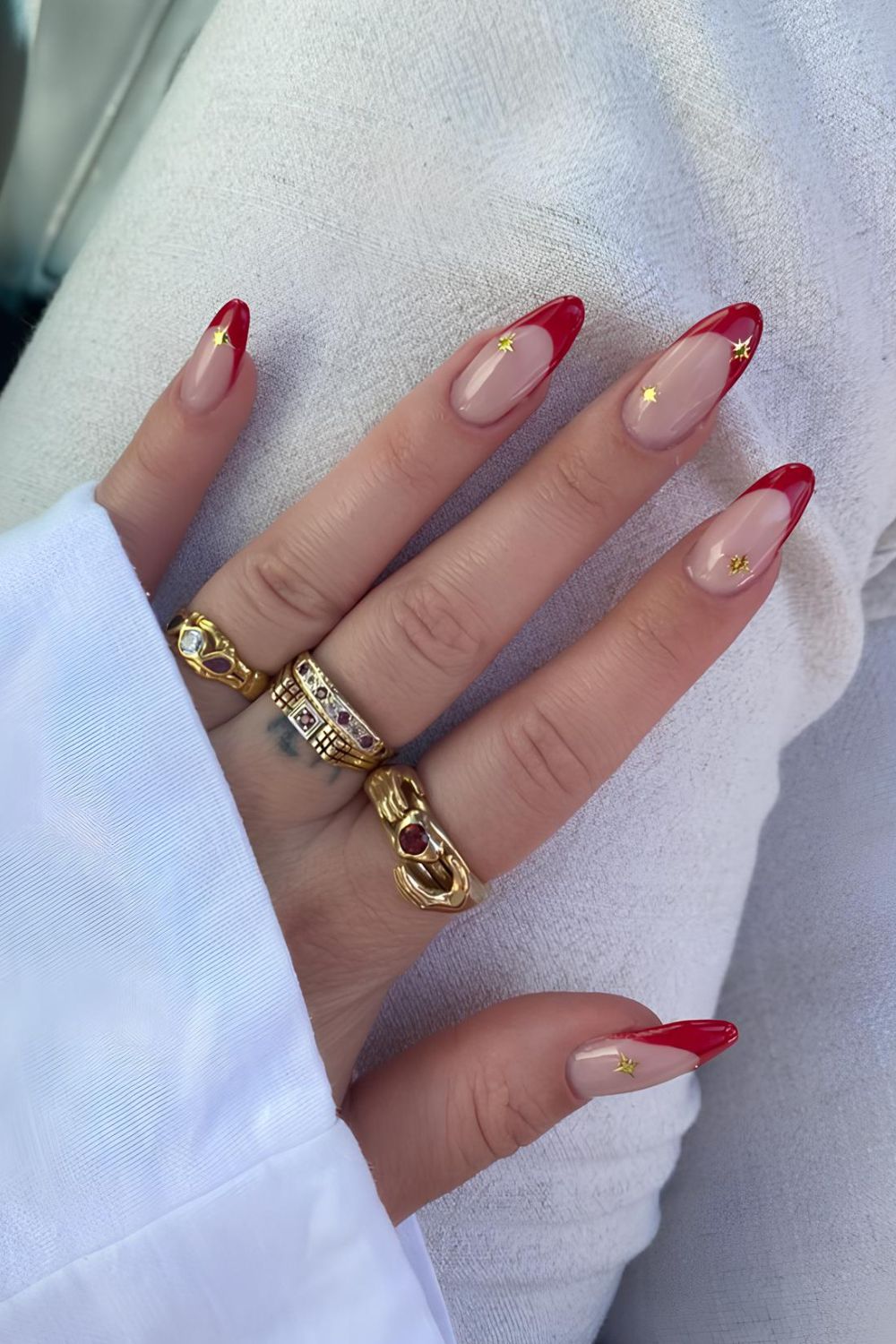 Red French manicure with chrome stars