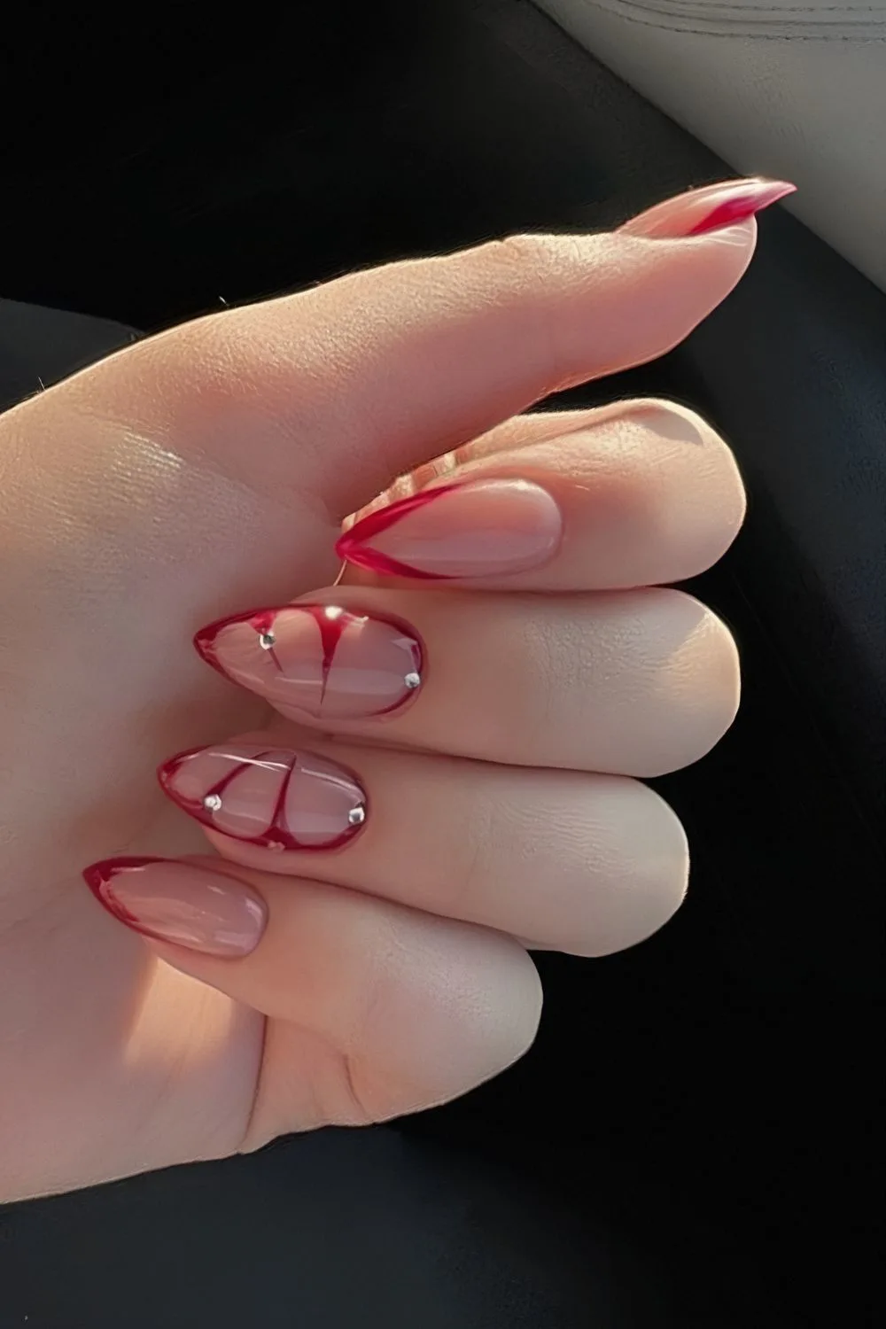 Red French nails with butterfly wing accent