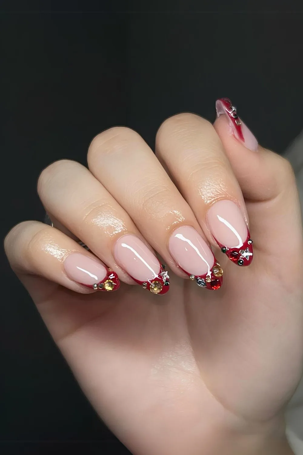 Red French nails with colorful rhinestones