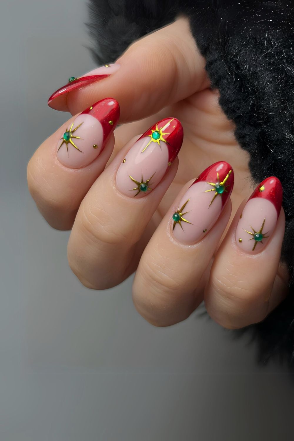 Red French nails with green celestial accents