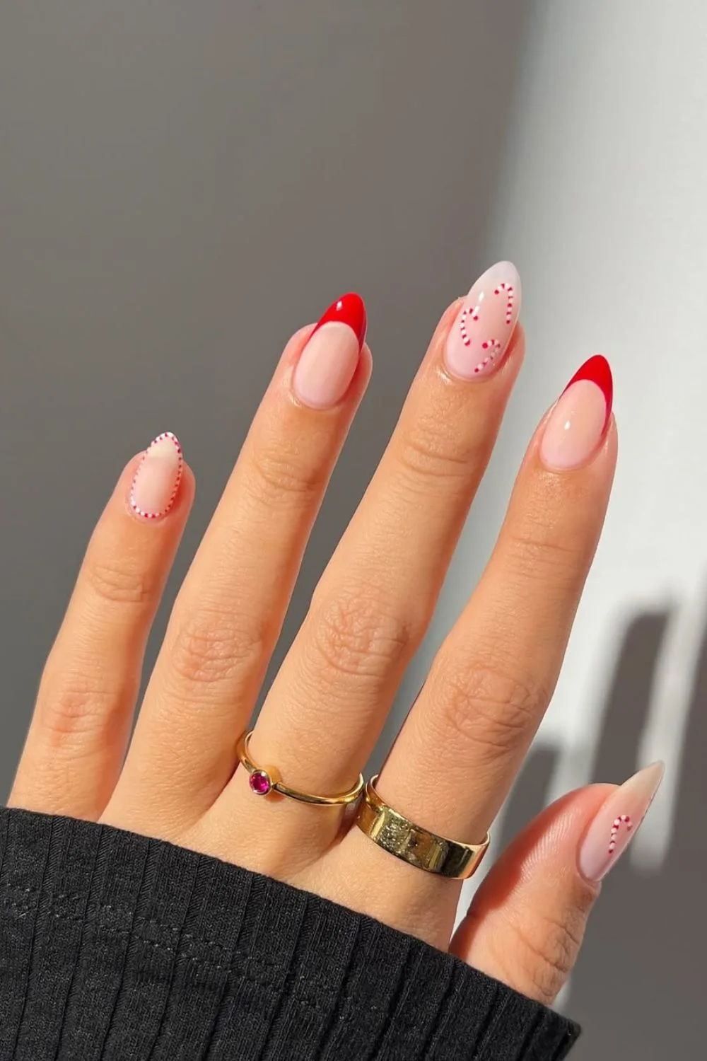 Red French tip nails with candy canes and milky base