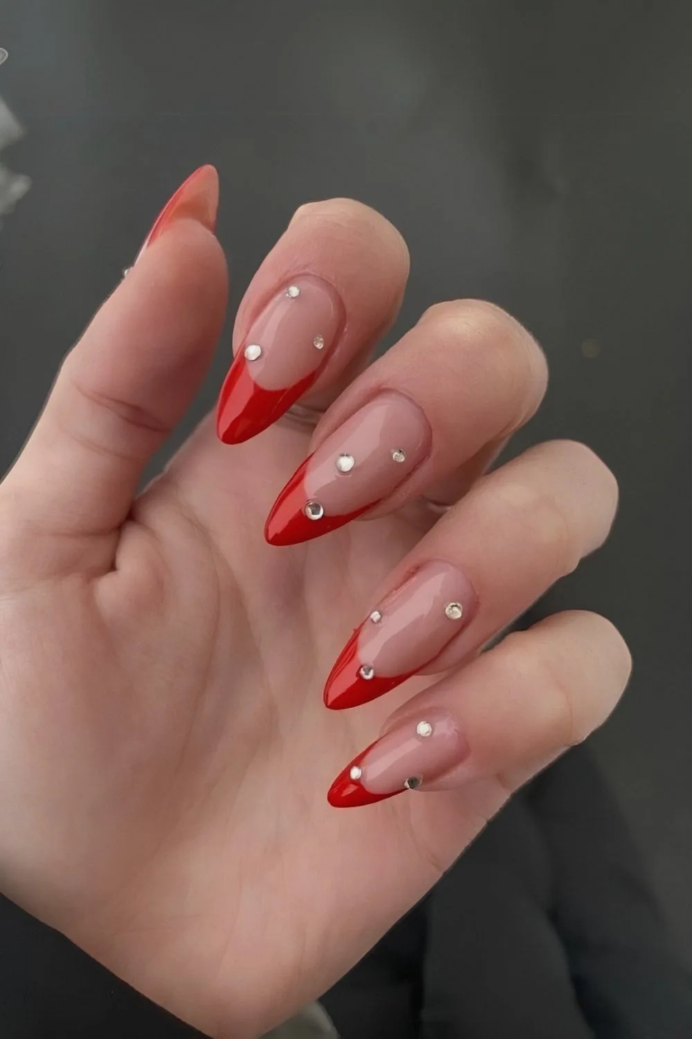 Red French tips with rhinestone accents