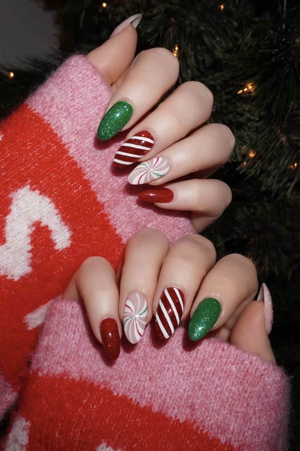 Red and green holiday nails with stripes and swirls