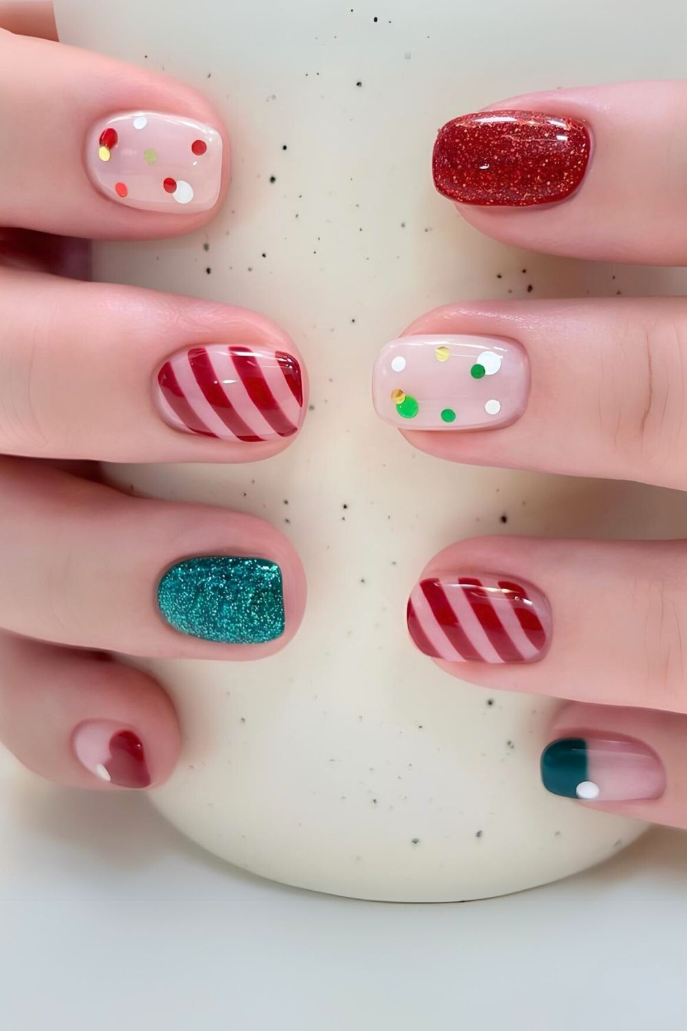 Red and green nails with stripes and polka dots