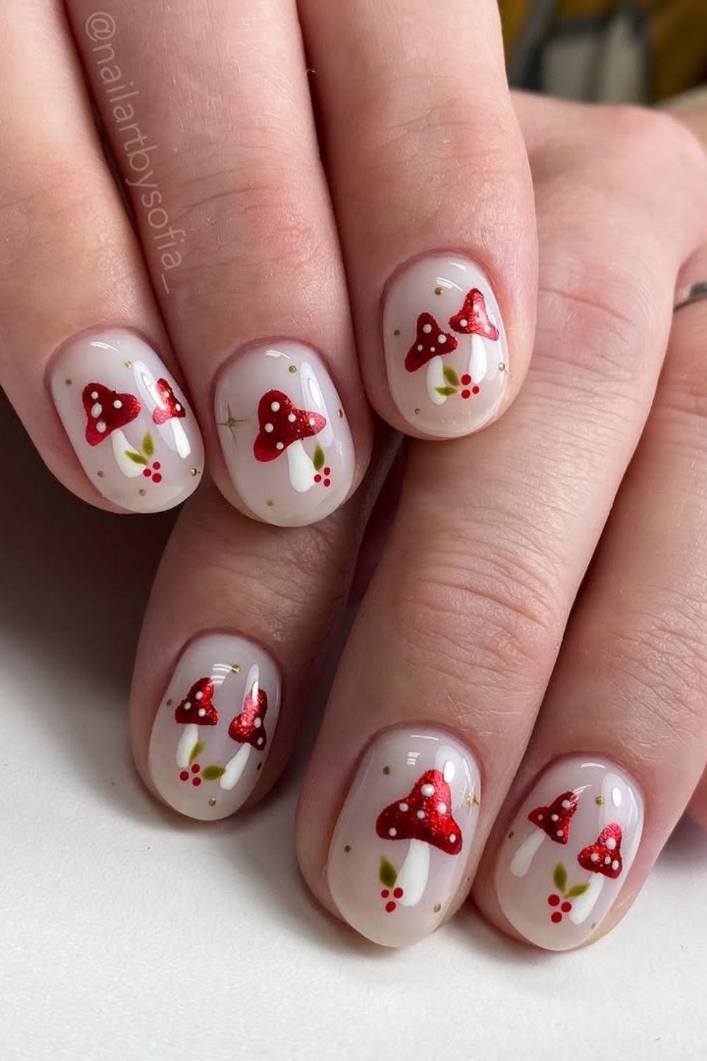 Red and white Christmas nails with mushrooms accents