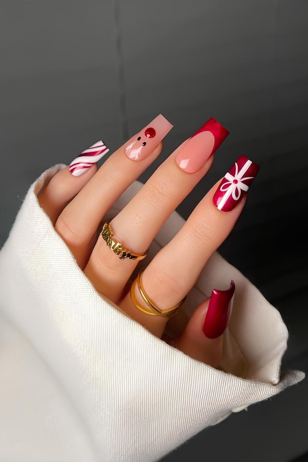 Red and white Christmas tip nails with reindeer accent