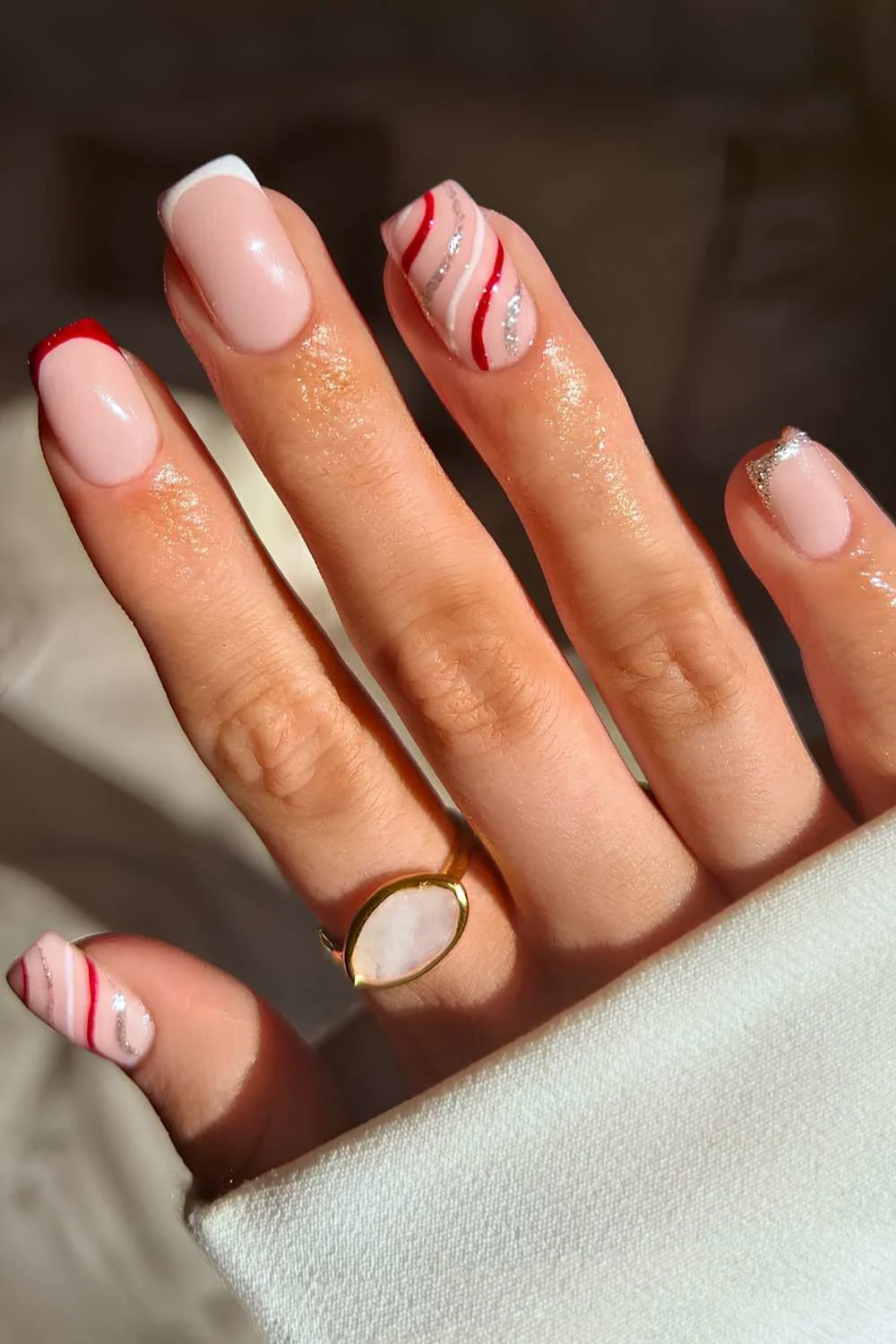 Red and white French nails with festive swirls