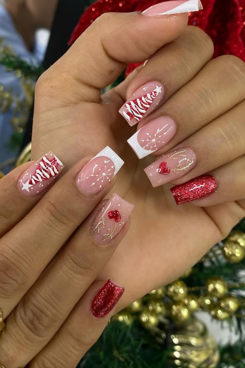 Red and white glitter Christmas nails with holiday ornament accents