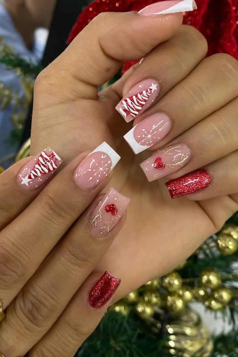 Red and white glitter Christmas nails with holiday ornament accents