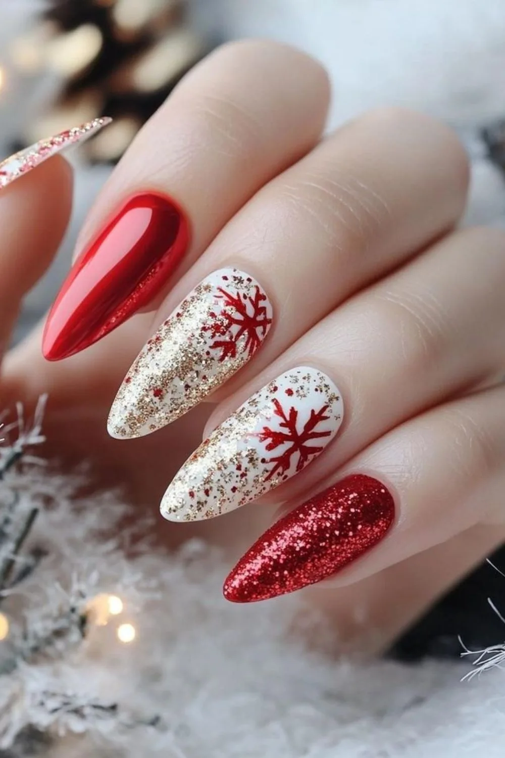 Red and white nails with gold glitter and snowflakes