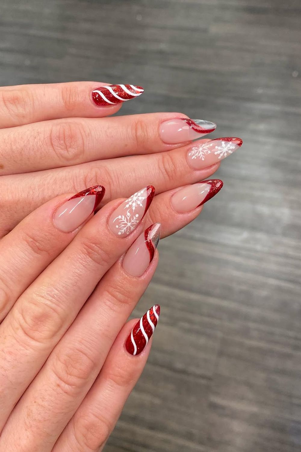 Red and white pointed French tip nails with swirls and glitter