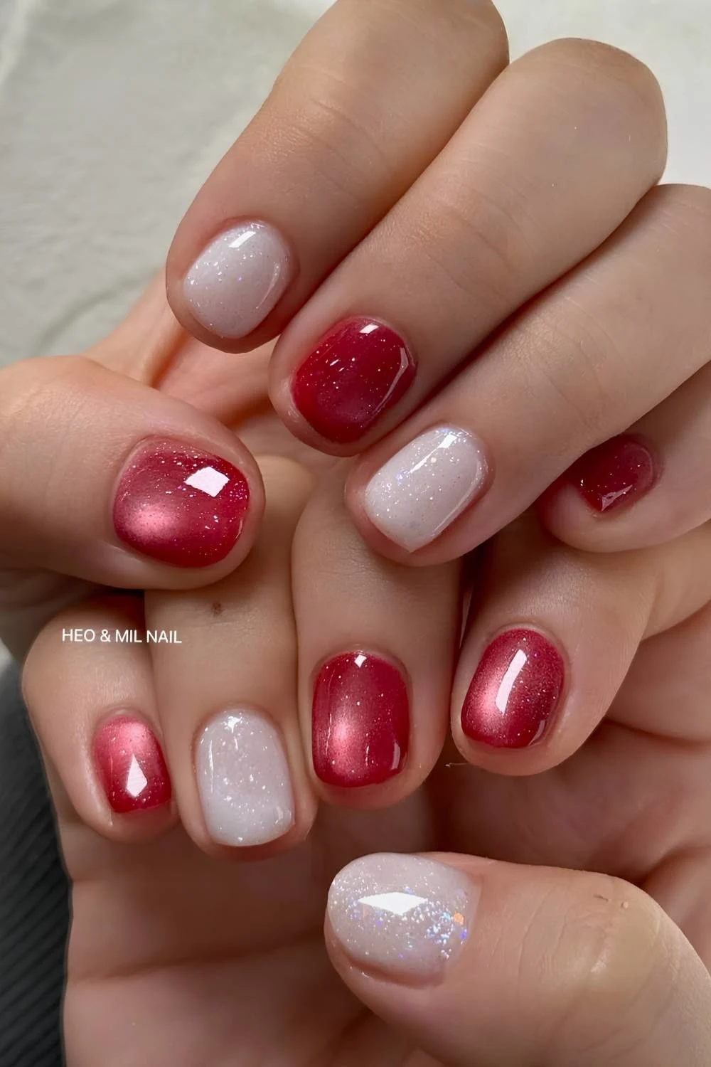 Red cat eye nails with shimmery white accents