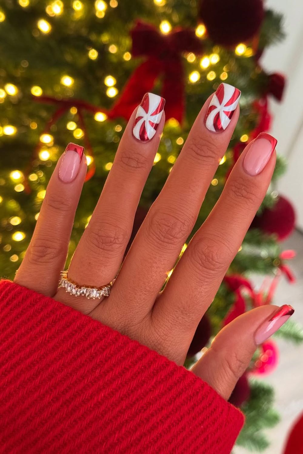 Red chrome French nails with peppermint swirl accents