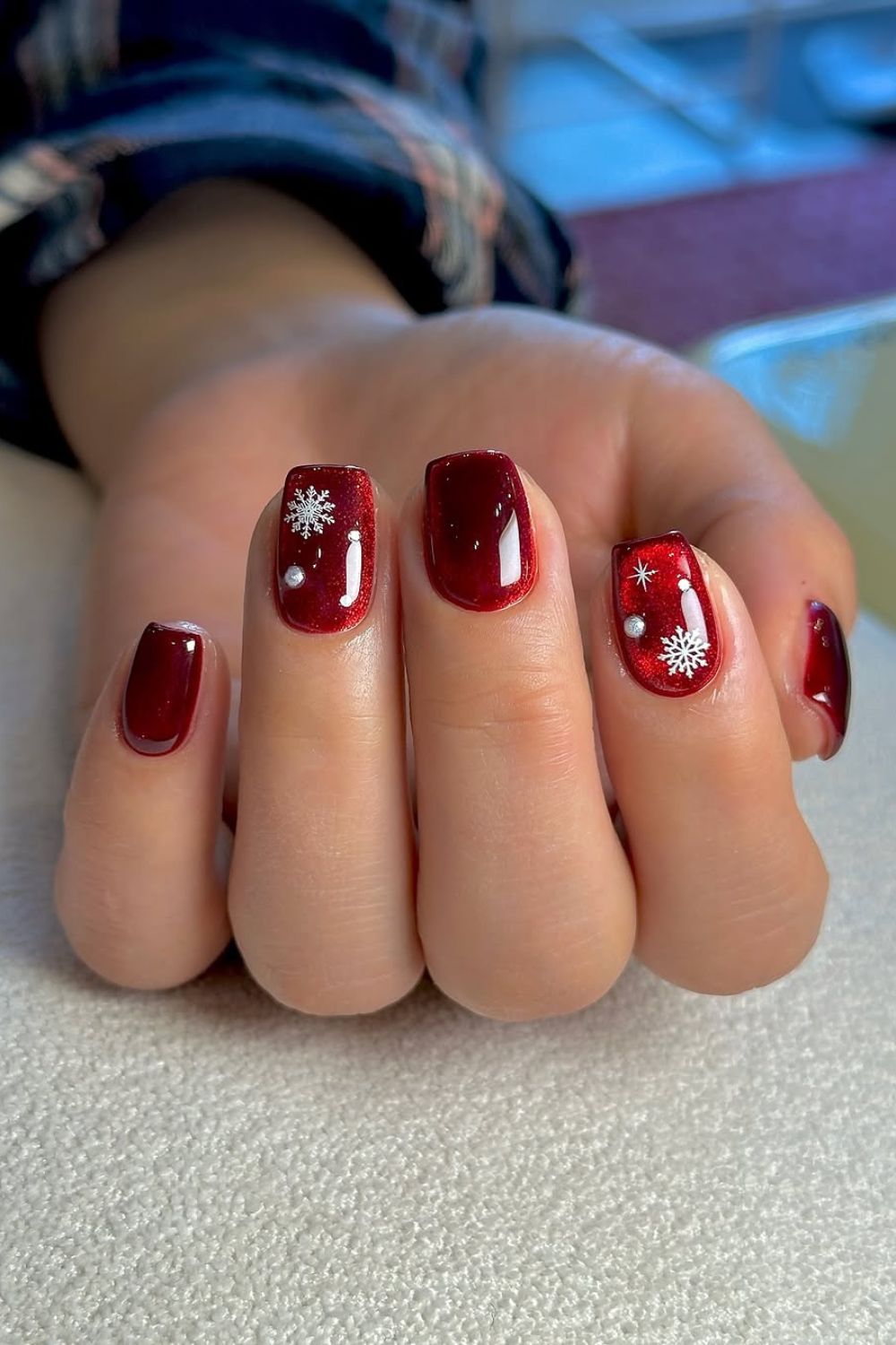 Red glass nails with white snowflake accents