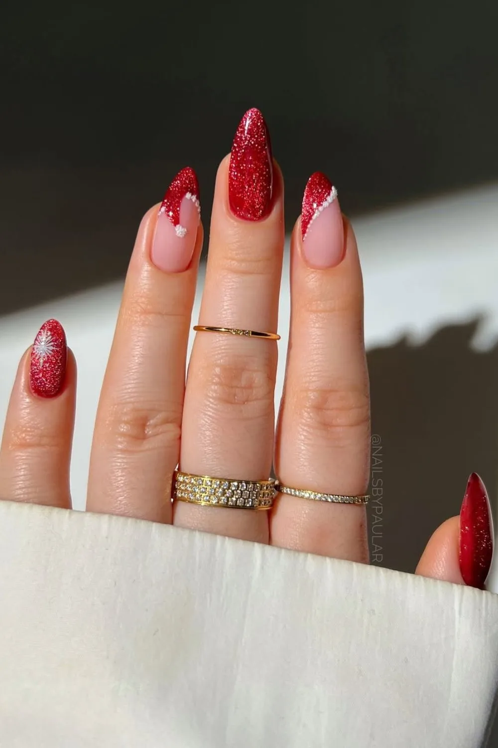 Red glitter French tip nails with Santa's hat accent