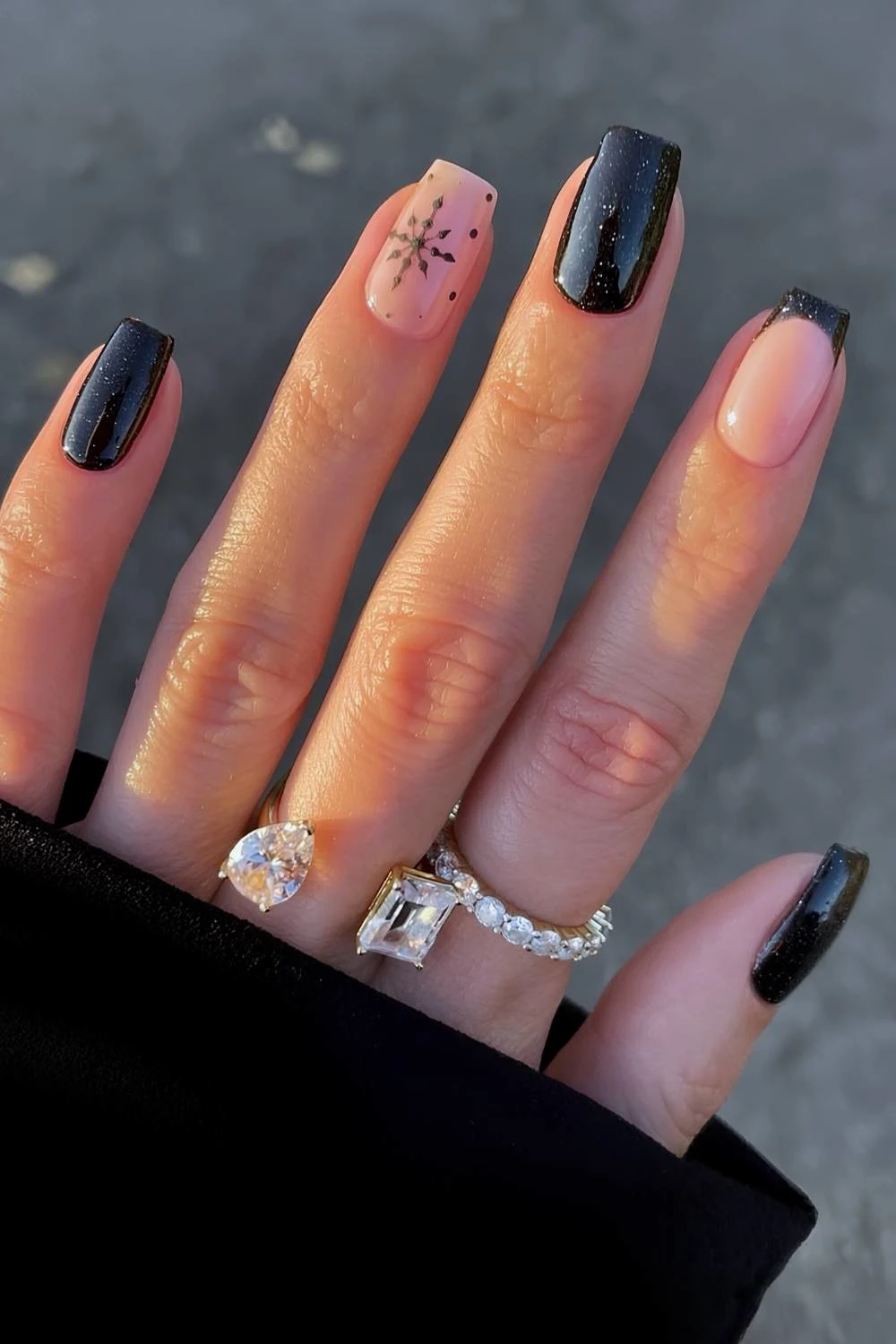 Shimmery black nails with snowflakes