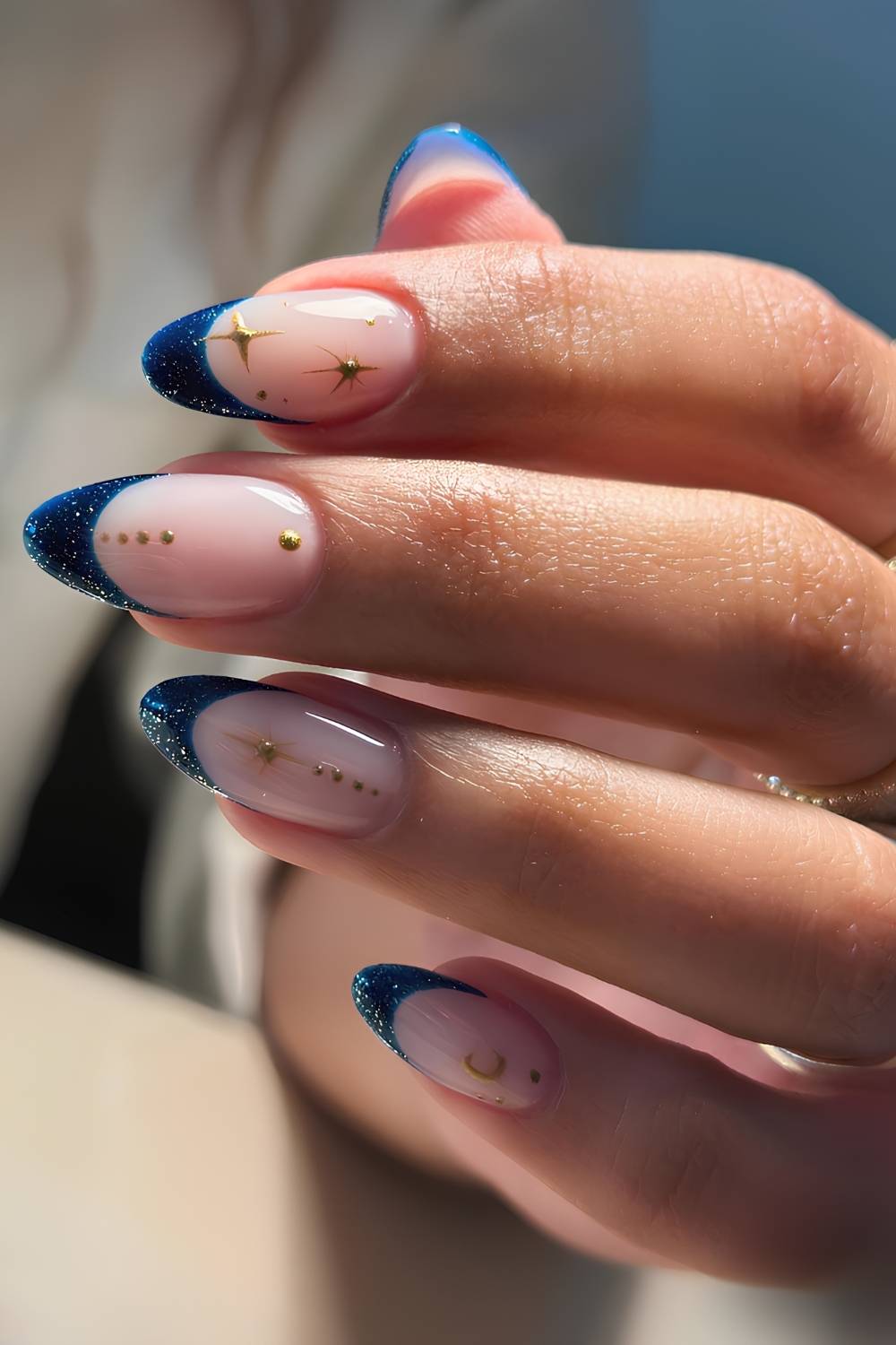 Shimmery dark blue French mani with gold stars