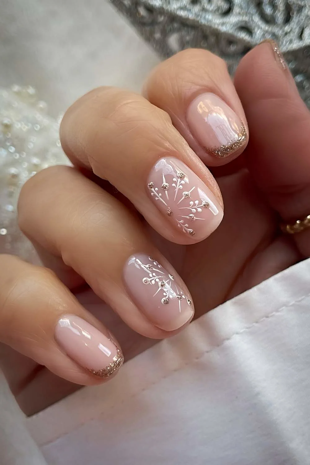 Short gold glitter French mani with snowflakes