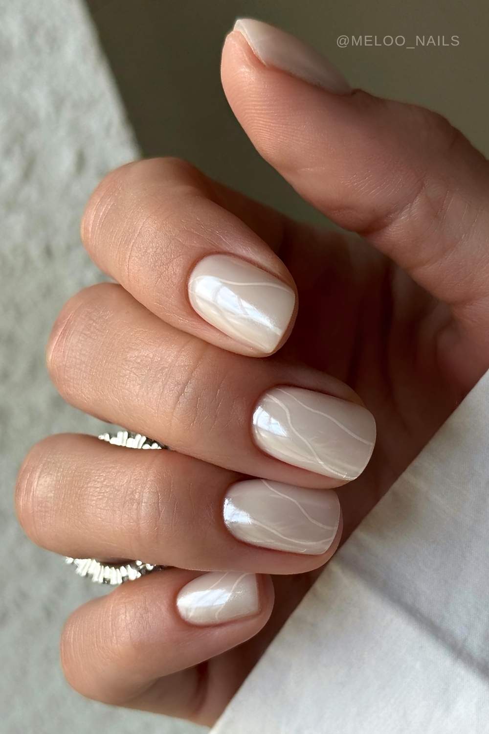Short white chrome nails with line art