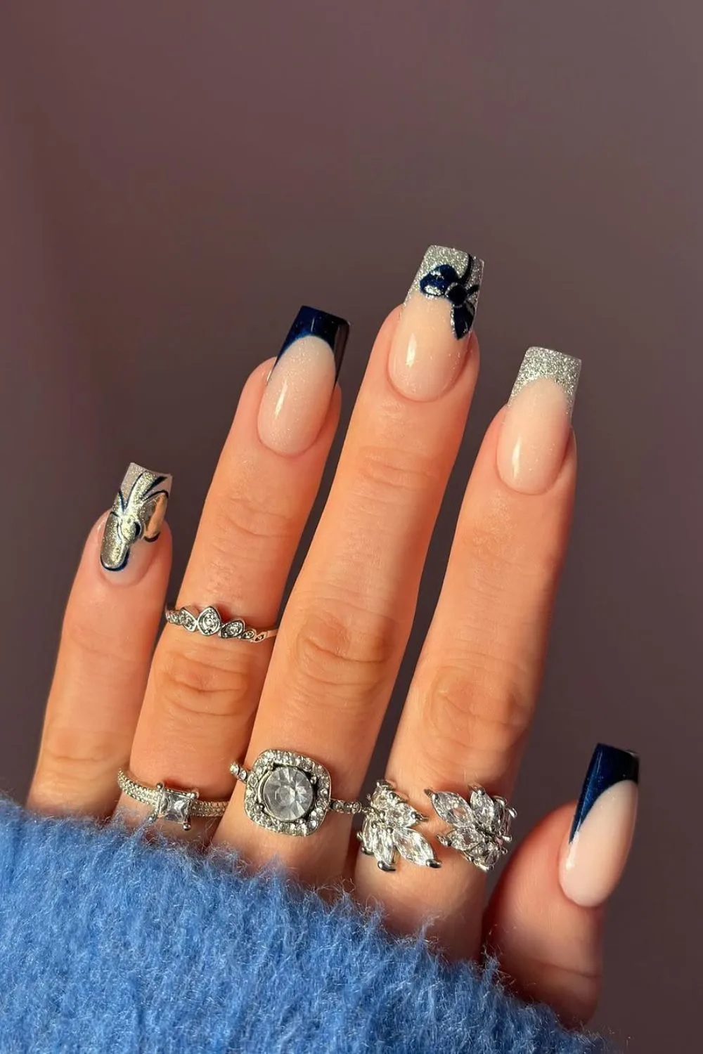 Silver and navy glitter French tip nails with navy bow accent