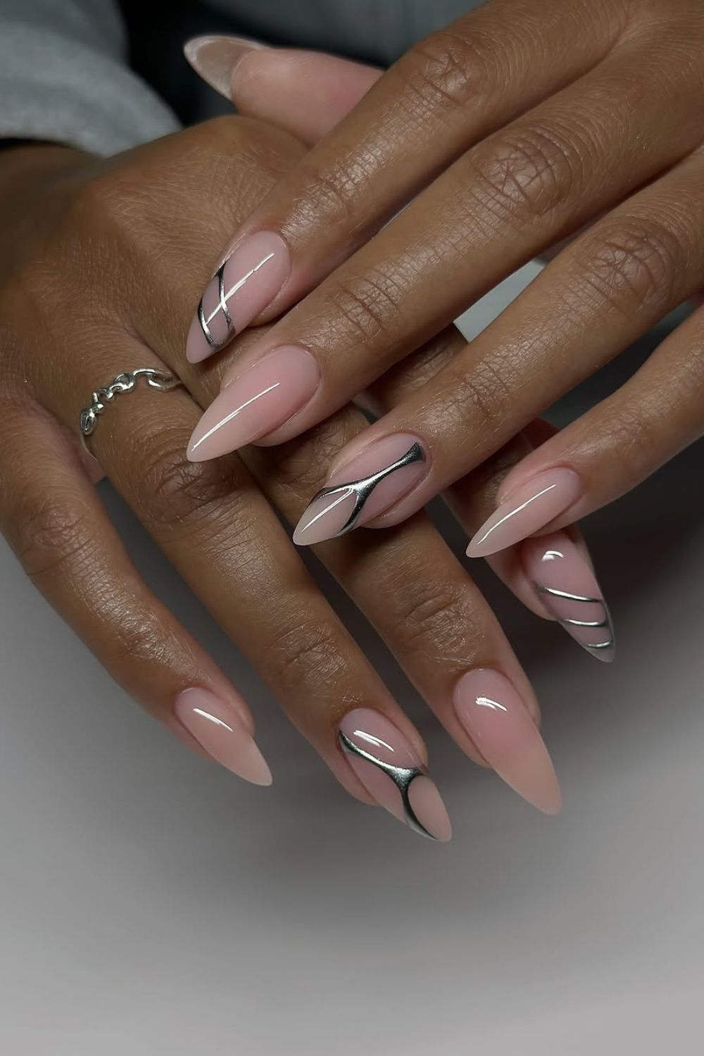 Silver chrome accents on nude nails