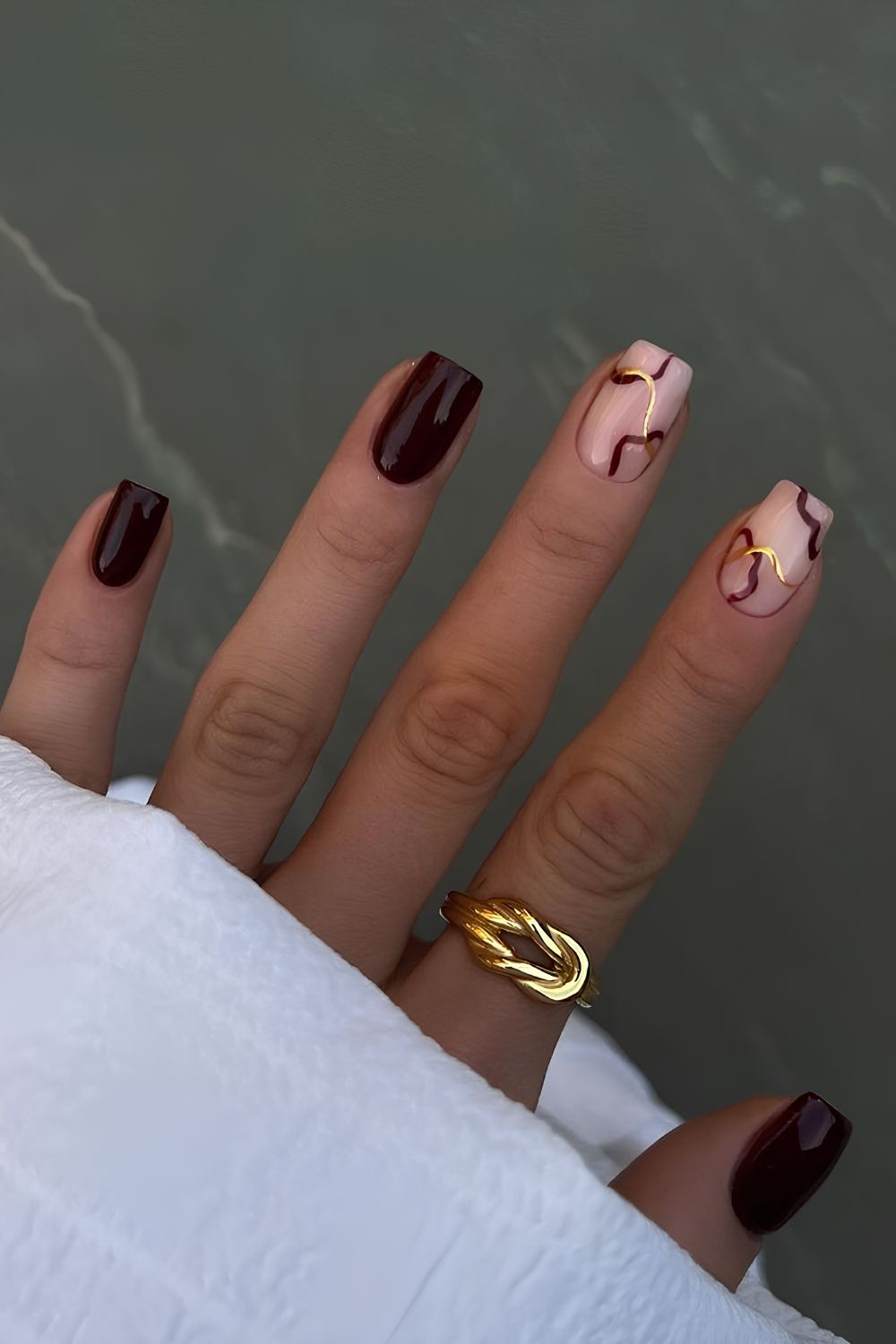 Sultry burgundy nails with swirl design