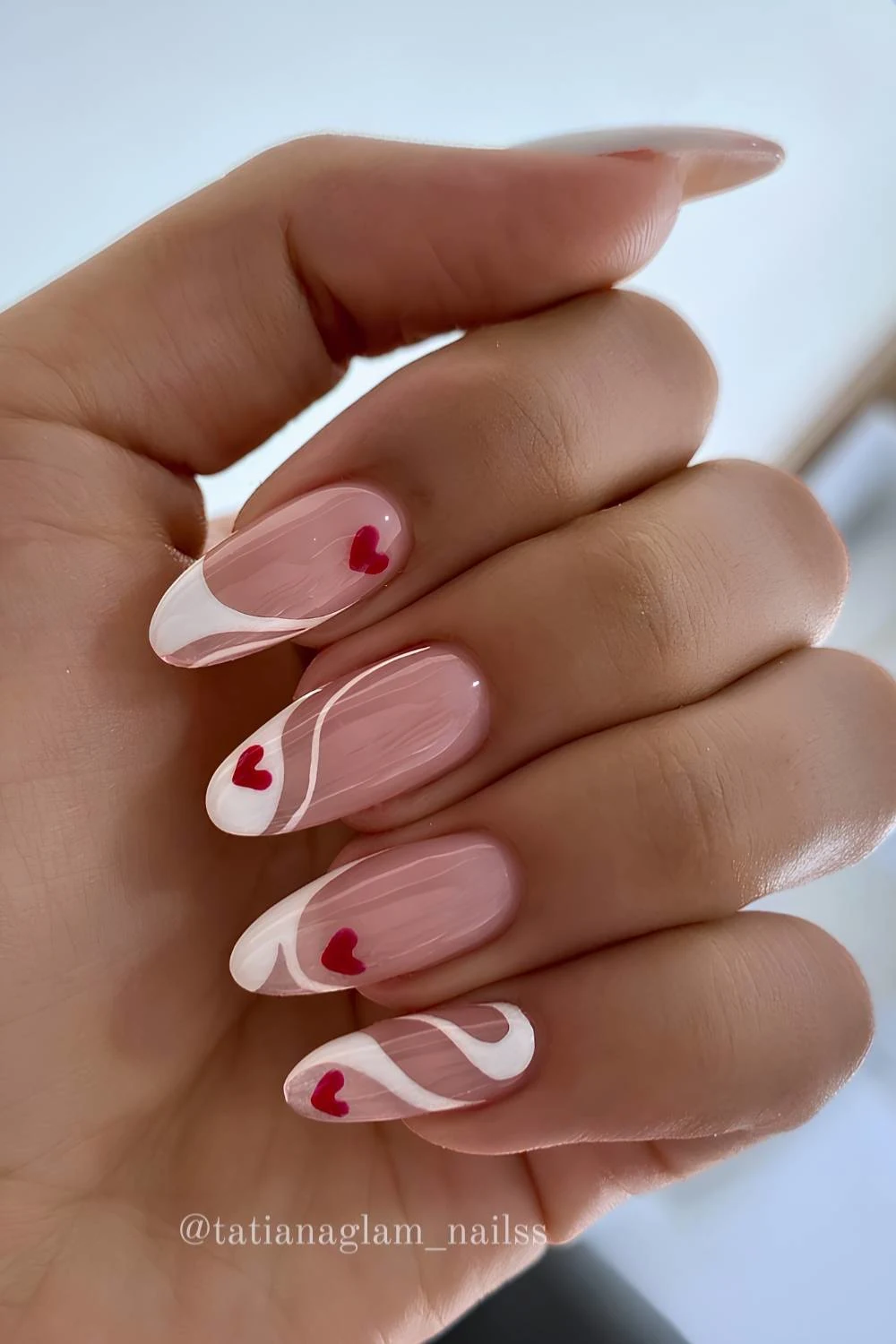 Swirly white French mani with red hearts