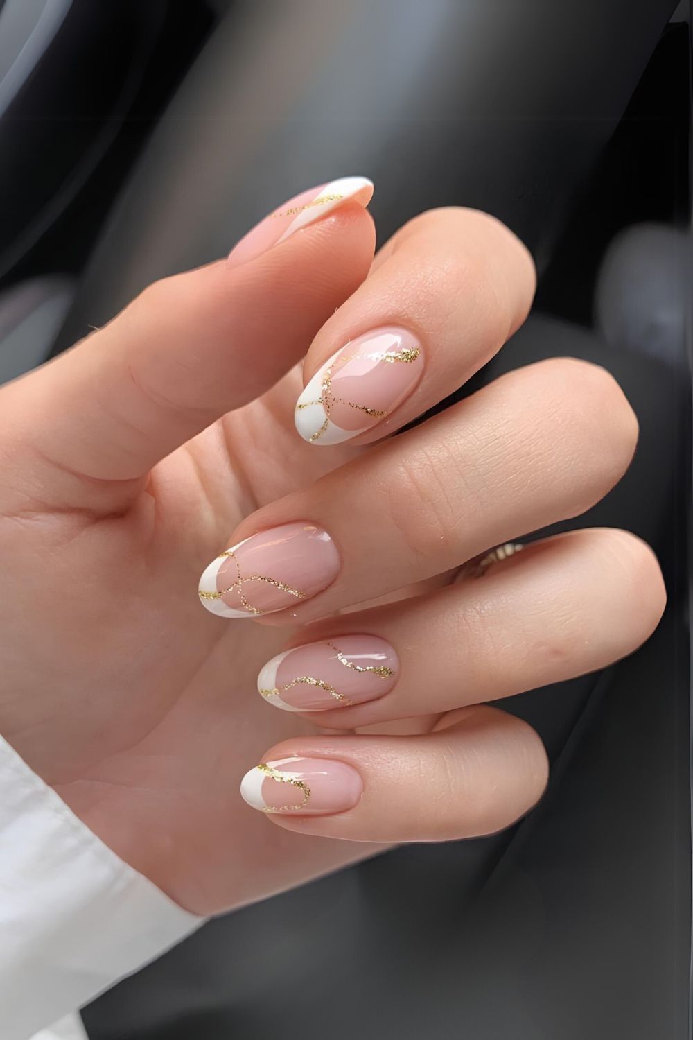 White French nails with gold swirls