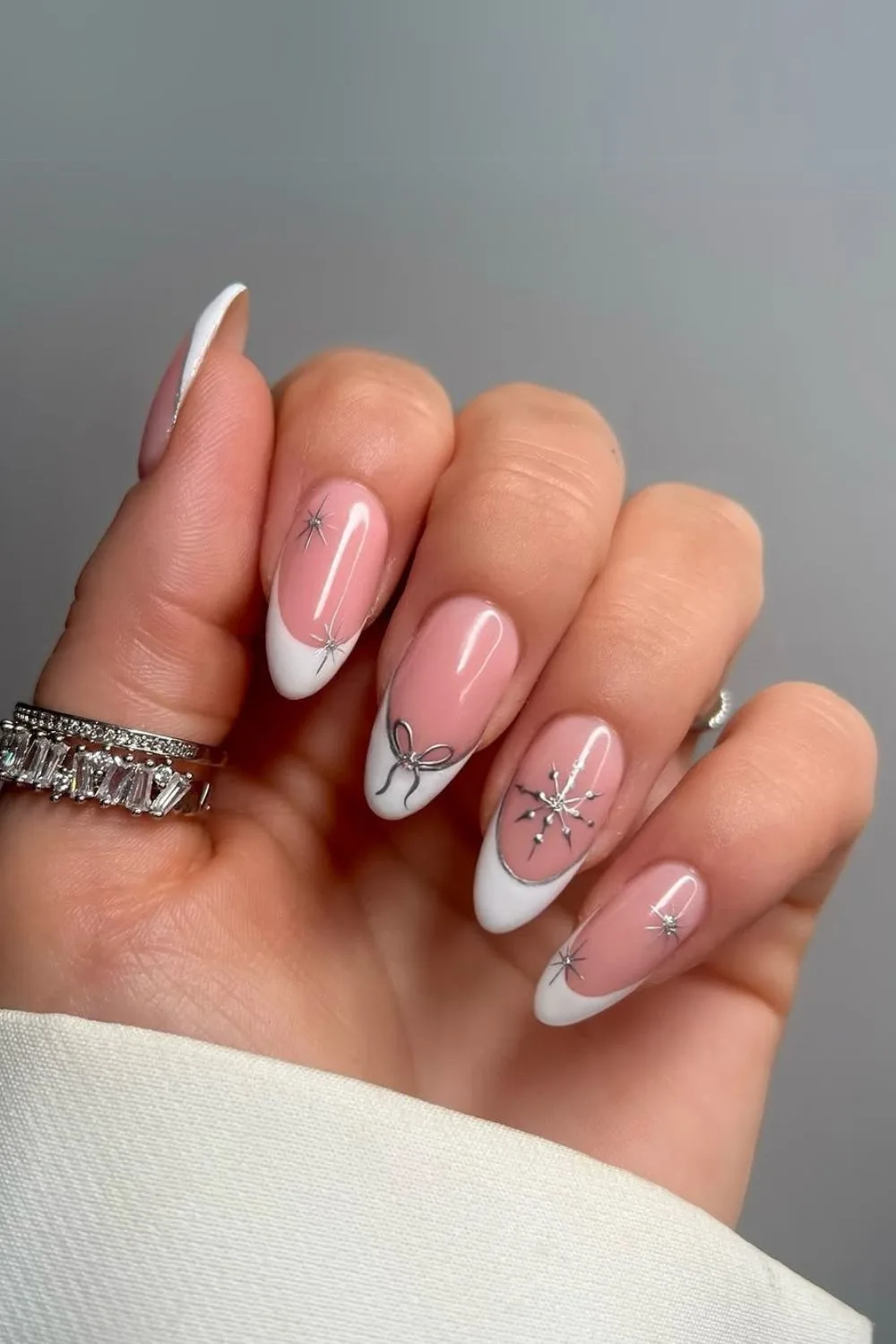 White French tip nails with silver snowflakes