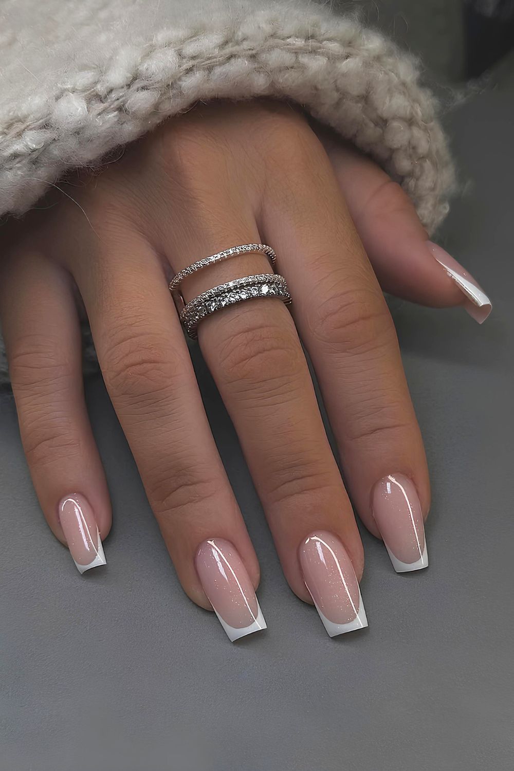 White French tip nails with subtle shimmer