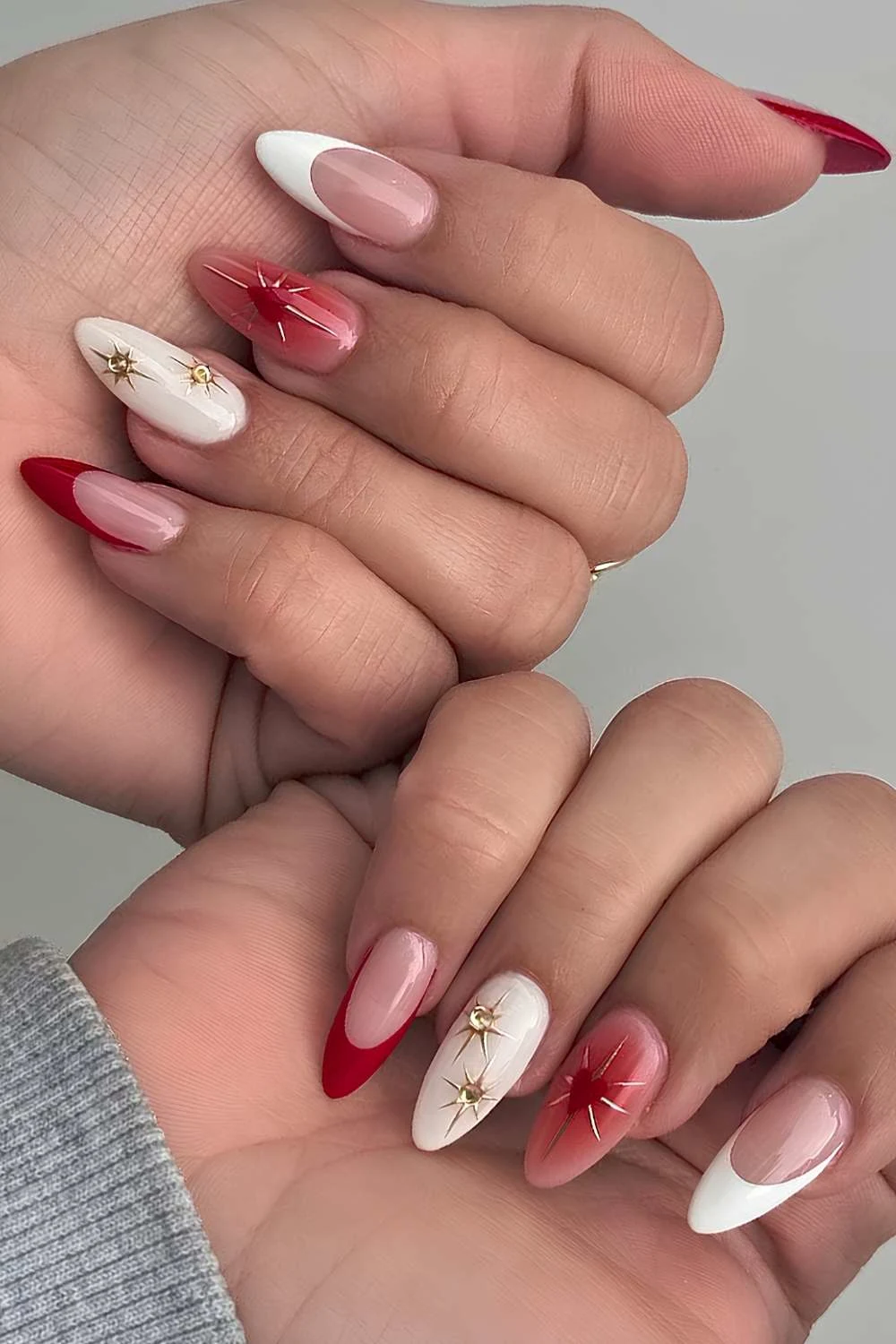 White and red nails with gold stars and hearts