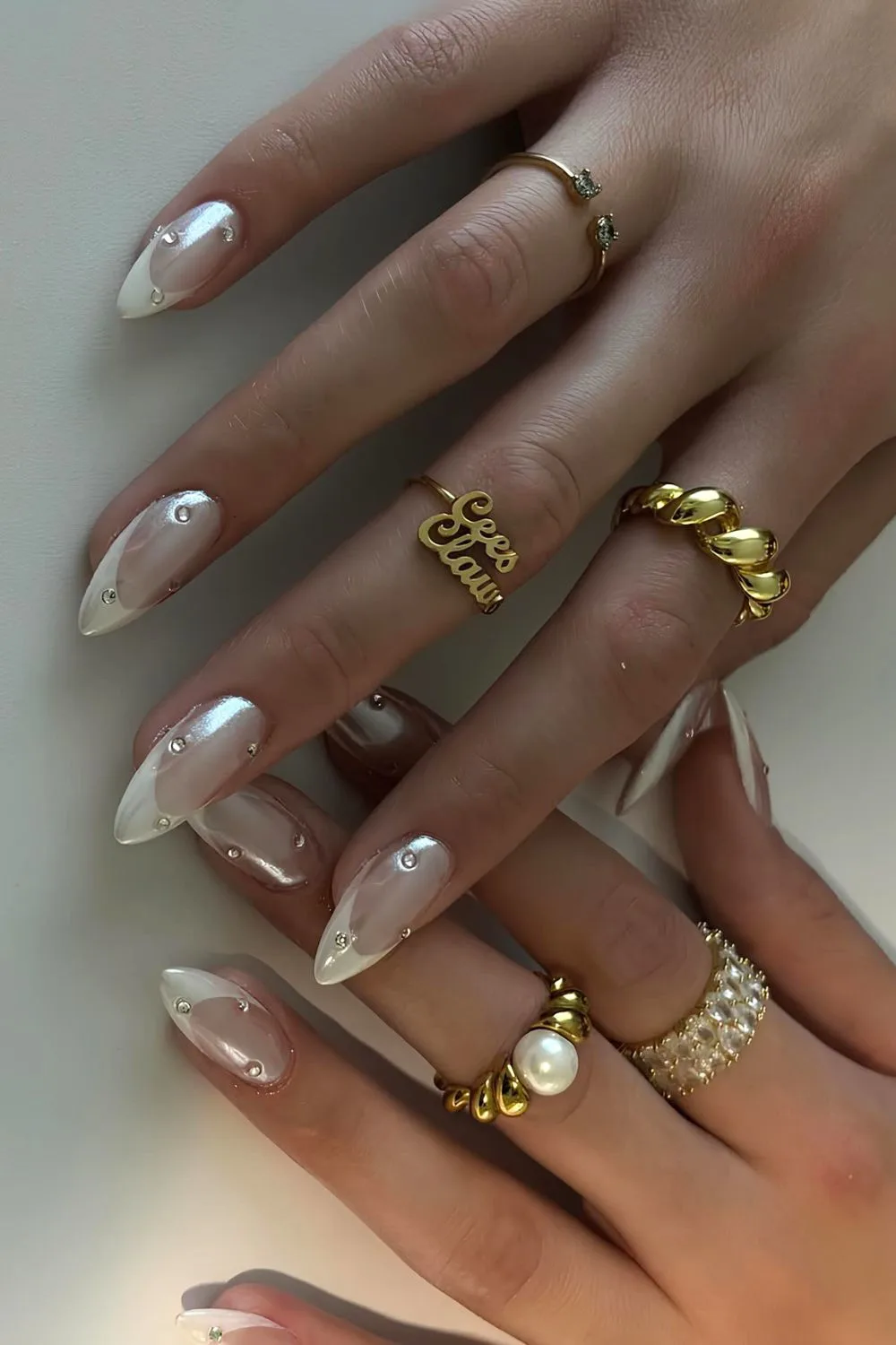 White chrome French nails with rhinestones