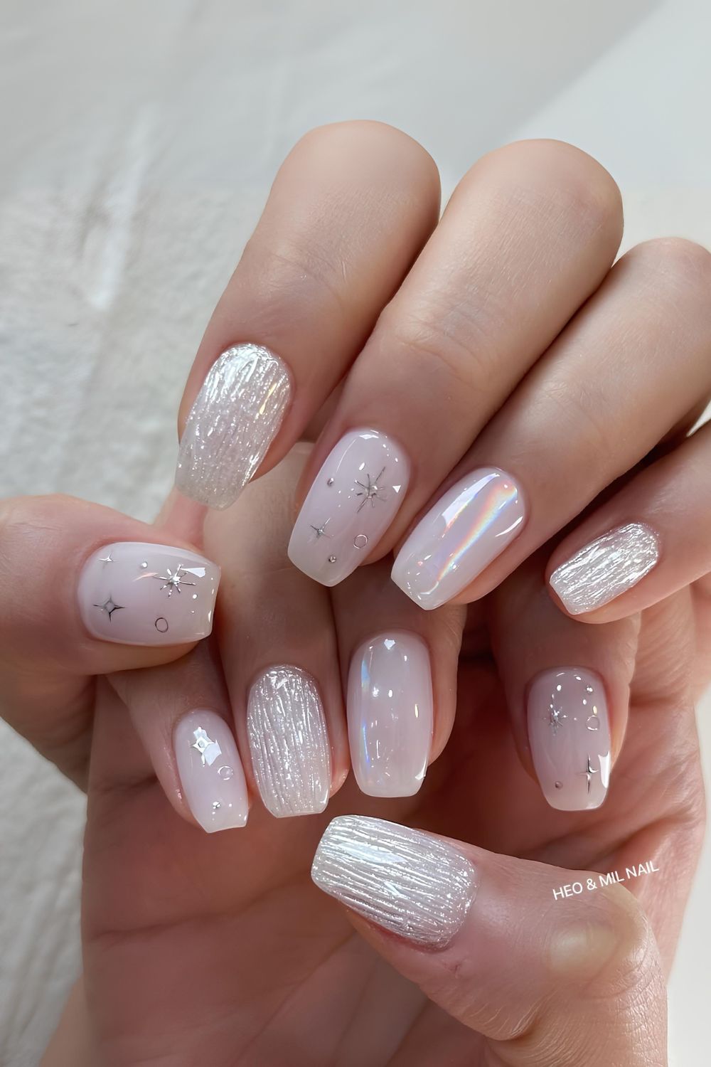 White chrome nails with celestial accents