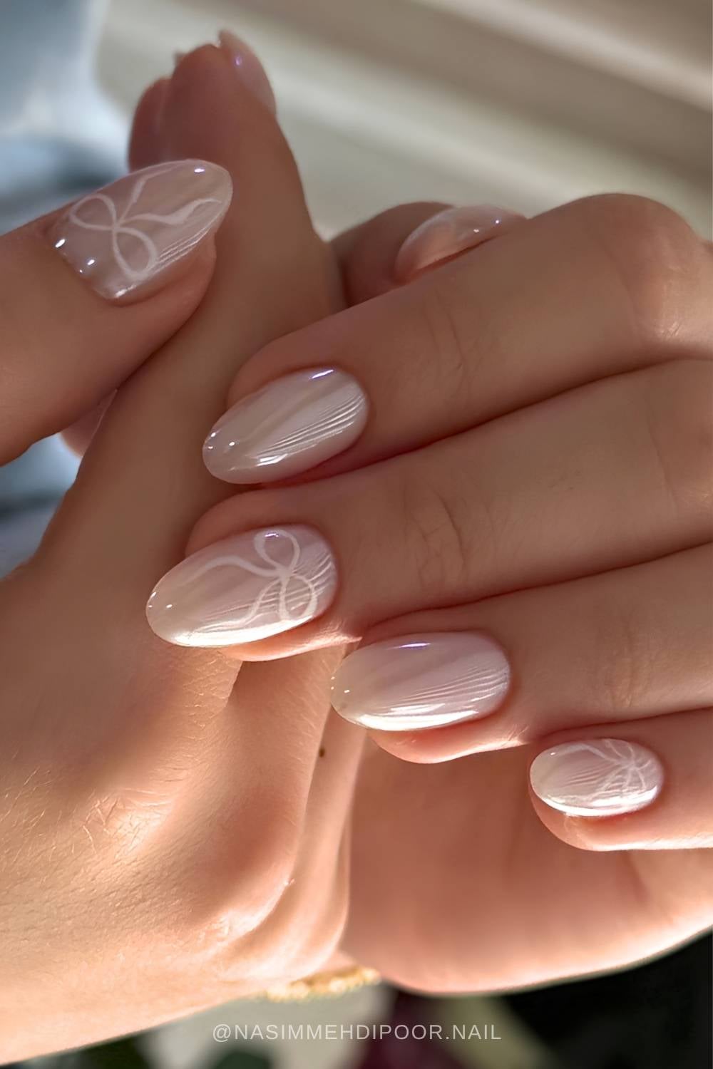 White chrome nails with delicate bow art