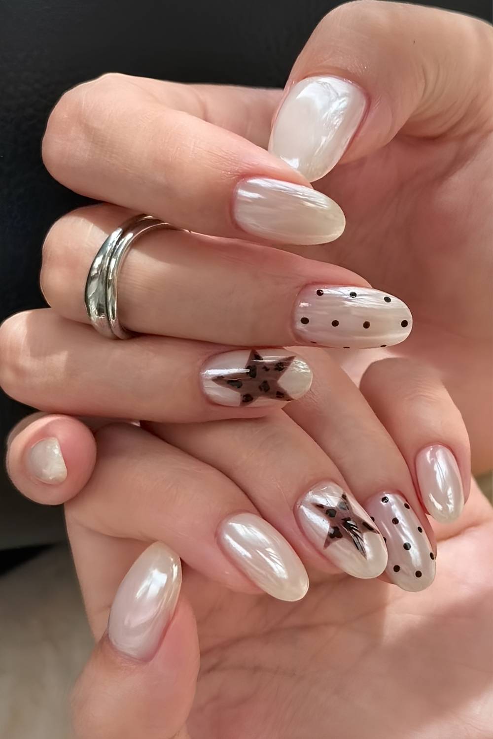 White chrome nails with stars and polka dots