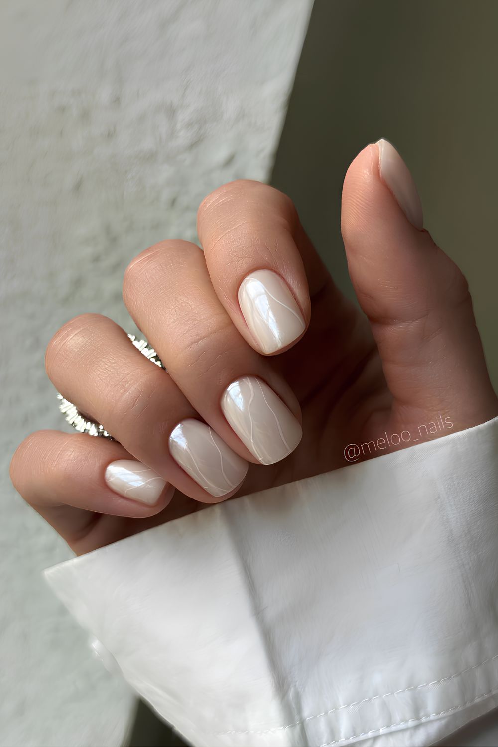 White chrome nails with swirl accents