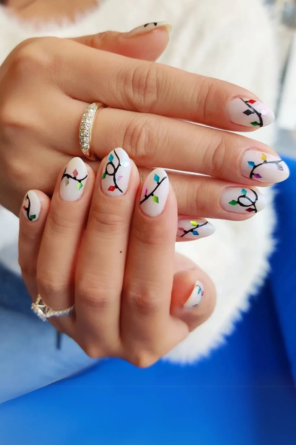 White nails with colorful fairy light art