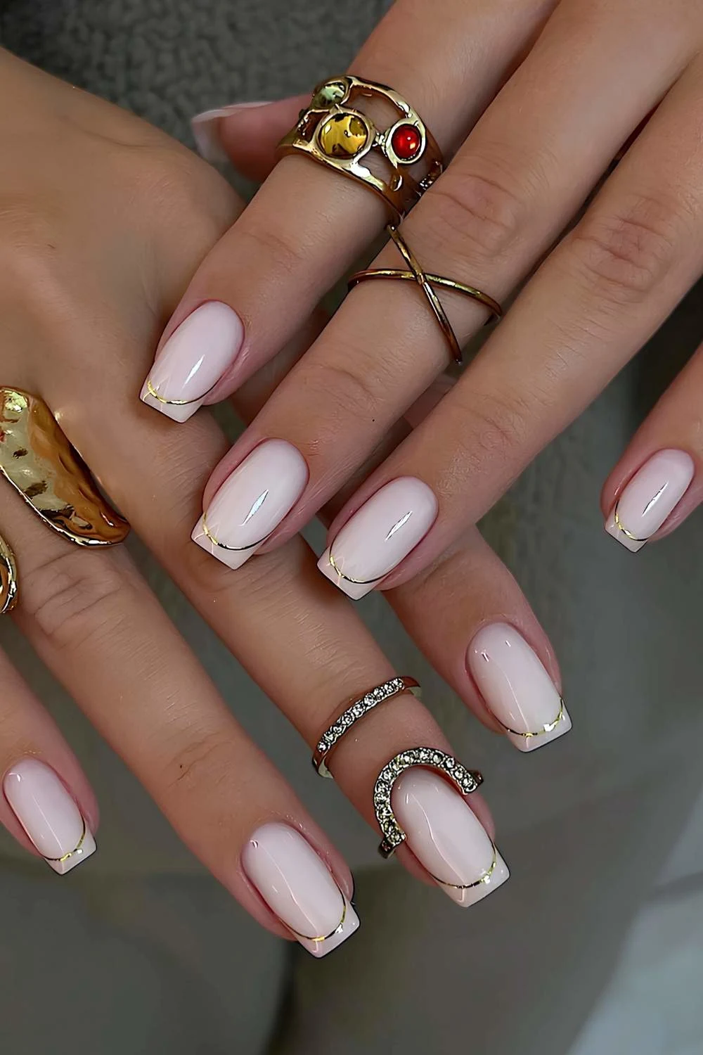 White nails with gold French tip outlines