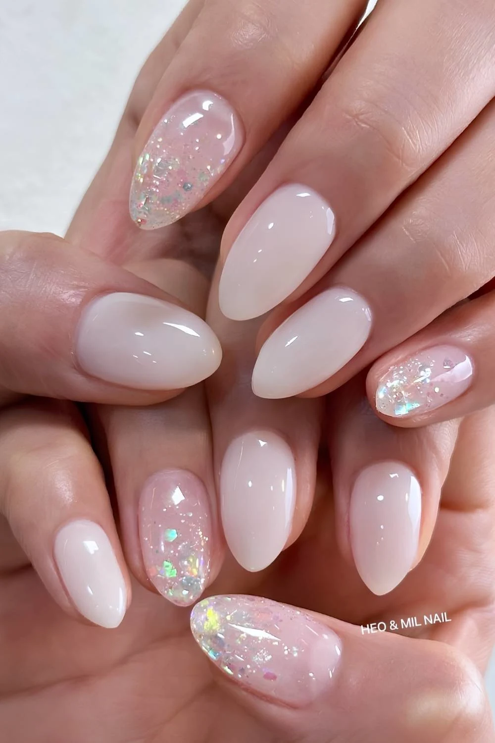 White nails with holographic glitter accents