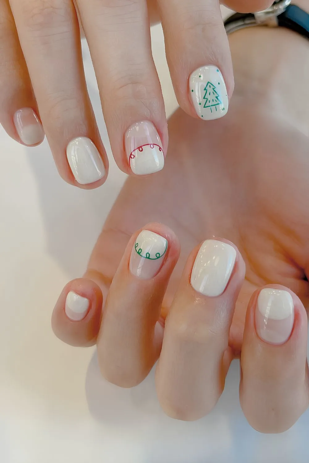 White nails with red and green festive accents