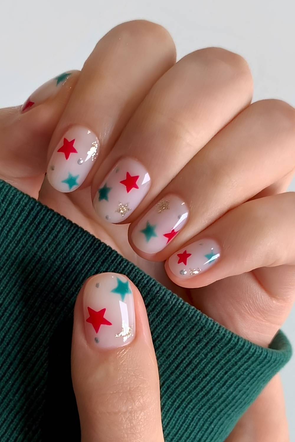 White nails with red and green star art